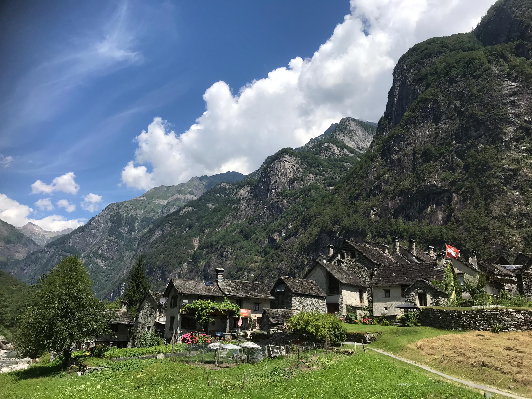 A group of old rustic houses surrounded by mountains. Taken in Bavona Valley in Ticino, Switzerland.